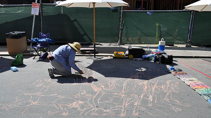 Cheryl mists water onto the pounced image to set it