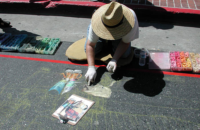 Wayne paints the camper's backpack
