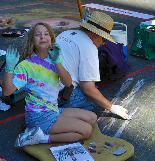 Catie shows off her cookie while Wayne paints