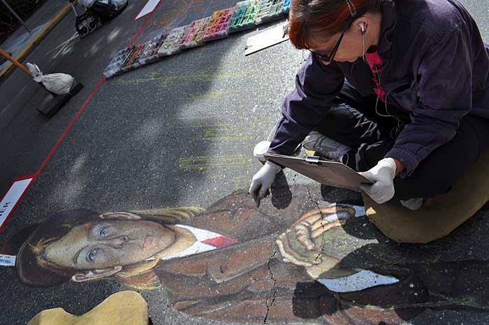 Cheryl paints the camper's hands