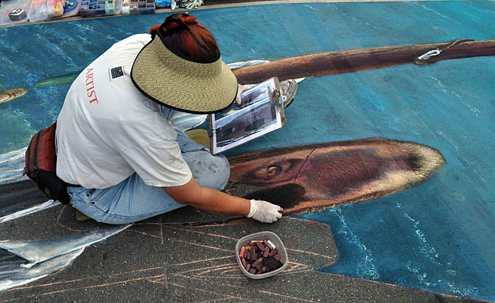 Side view of Cheryl painting the pirate face