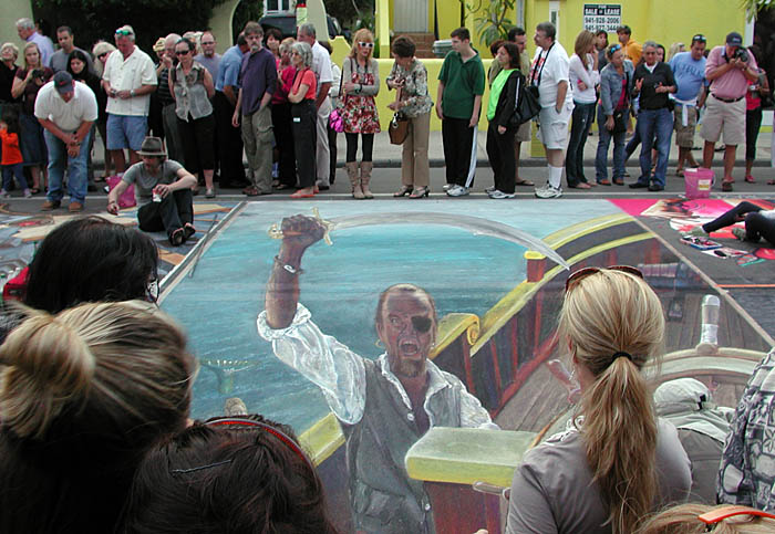 Viewing the painting from over the heads of the crowd